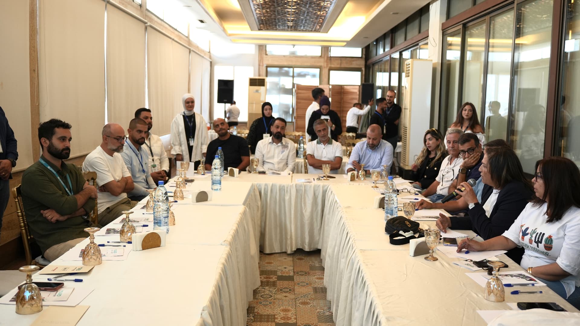 Youth and decision-makers seated around tables during a YARD roundtable discussion.